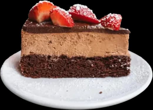 A slice of chocolate mousse cake topped with fresh strawberries and powdered sugar